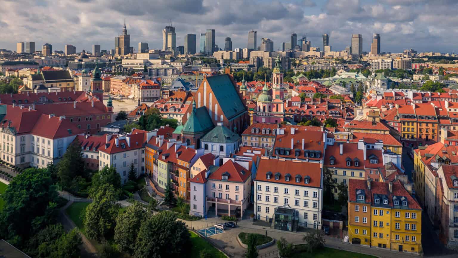 Warsaw Old Town rooftops with the modern skyline behind, Poland